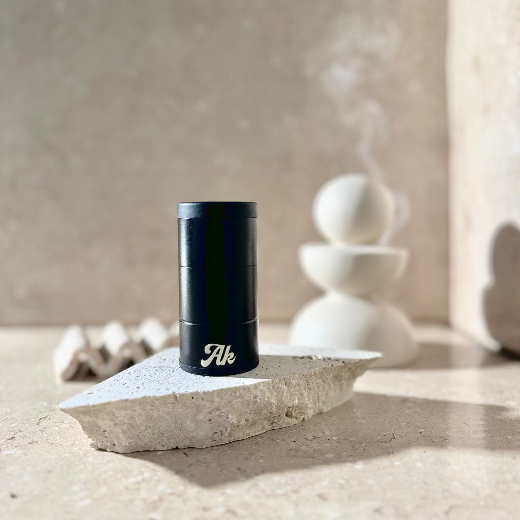 Akcomplice & Co's black and cream personal air filters for discreet plant-based medicine consumption, portable for home, office, car, and travel use