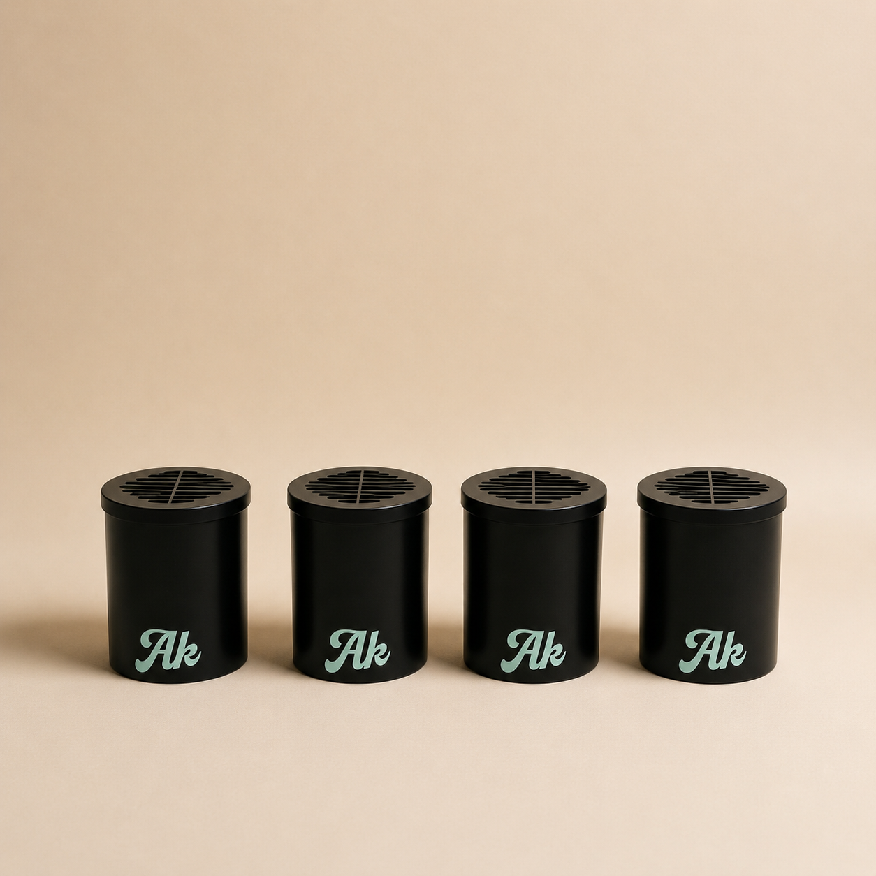 Personal air filter replacement cartridges bundle from Akcomplice & Co. with four black cartridges on a neutral background.