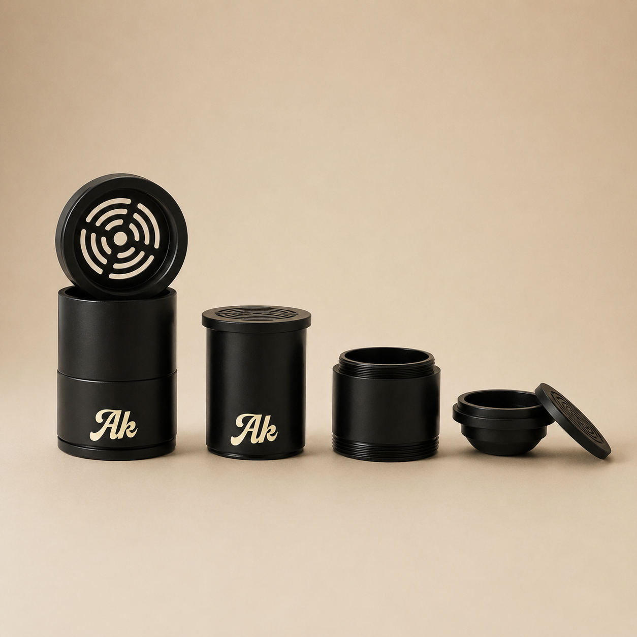 Set of black cylindrical containers with 'Ak' branding on a beige background