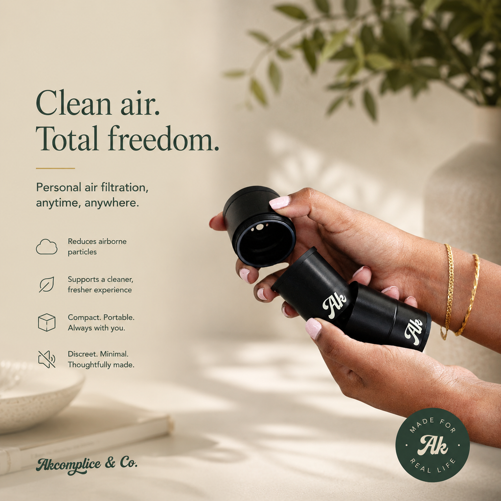 Hand holding a black personal air filtration device 