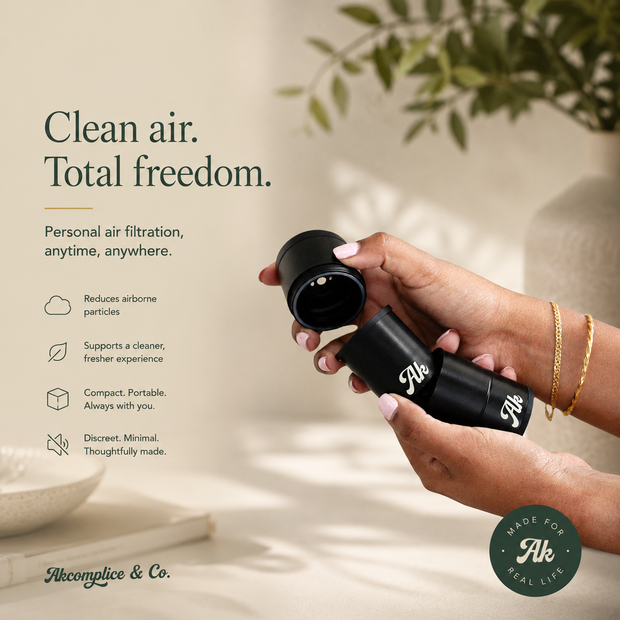 Hand holding a black personal air filtration device 